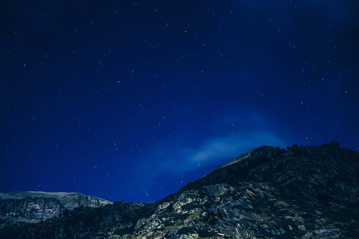stars low angle photography of mountain during nighttime rock
