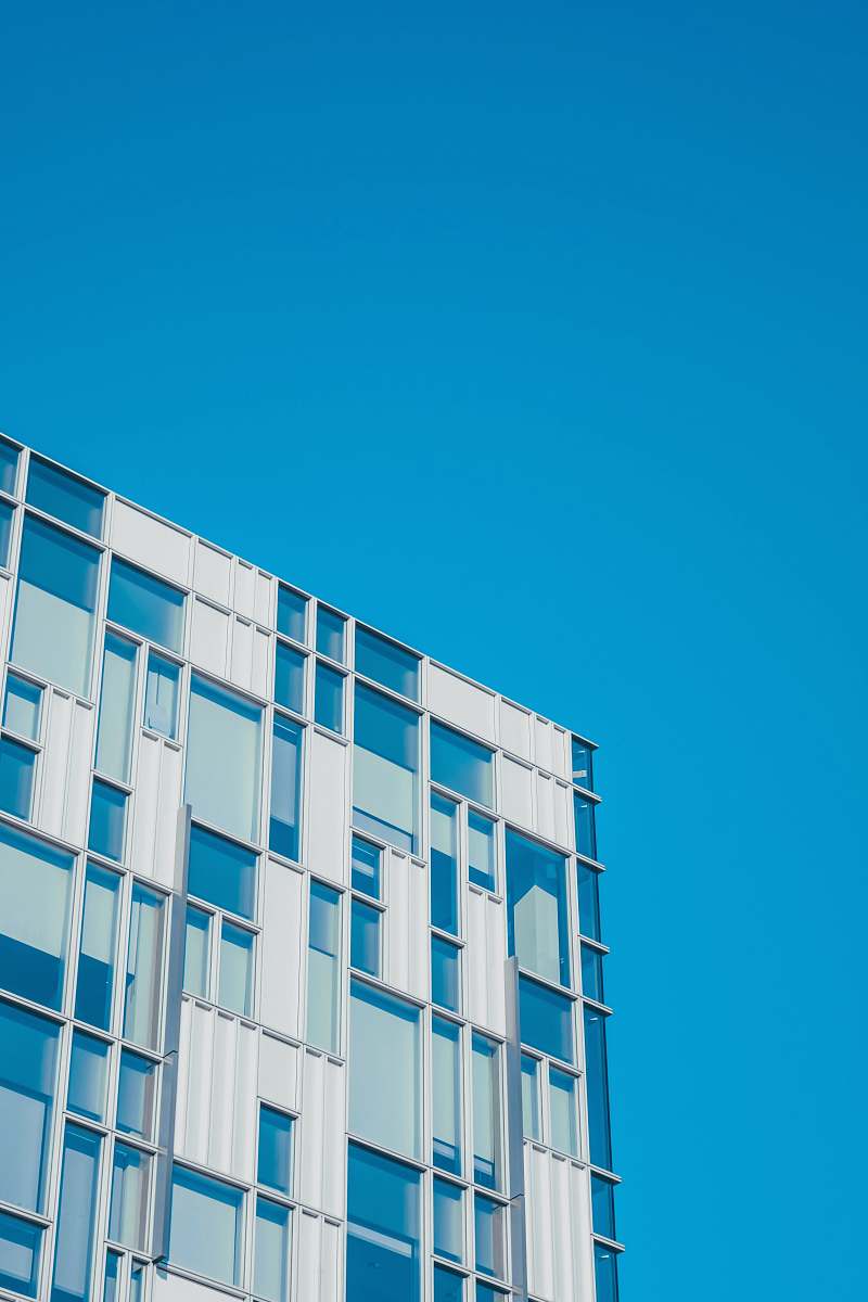building low angle photography of white and teal painted building housing