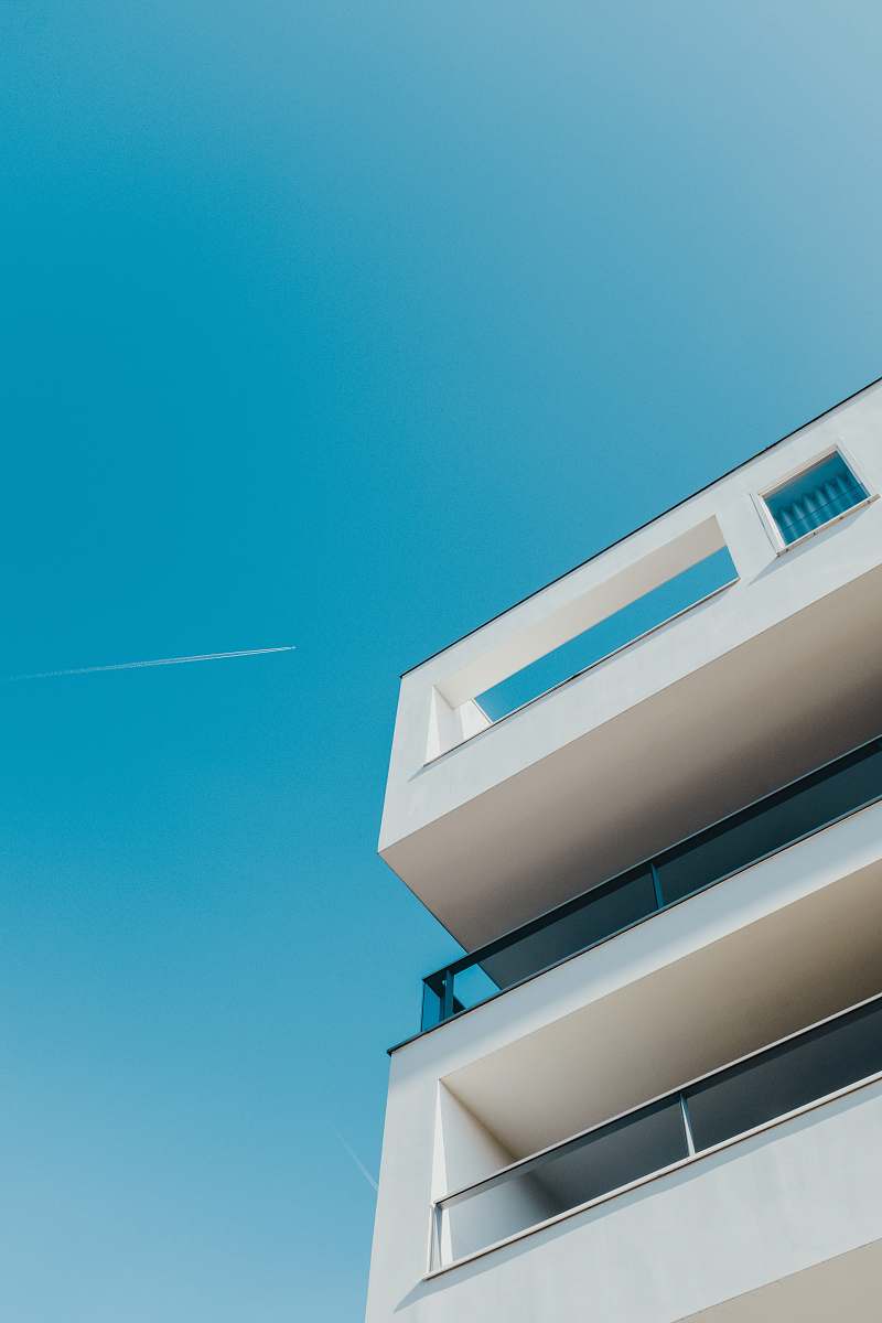 building low-angle photography of white building housing
