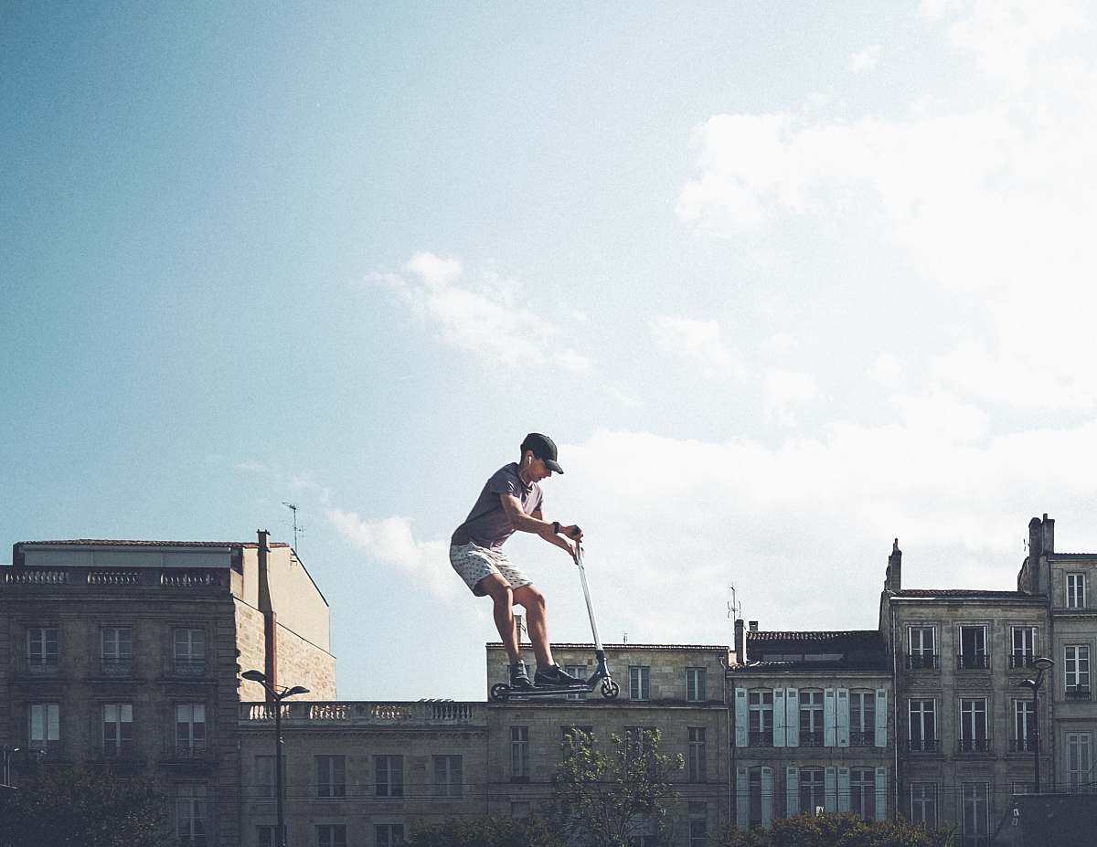 human man riding on black kick scooter person