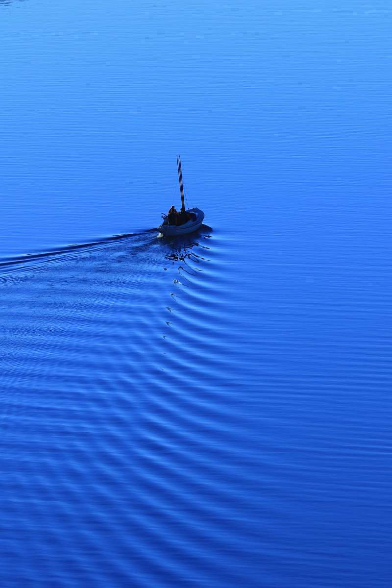 water man riding on boat on body of water sweden