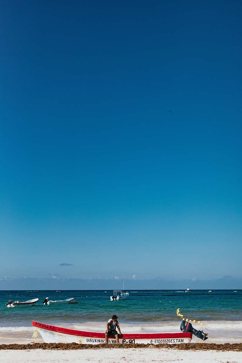 human man sitting on motorboat in beach person