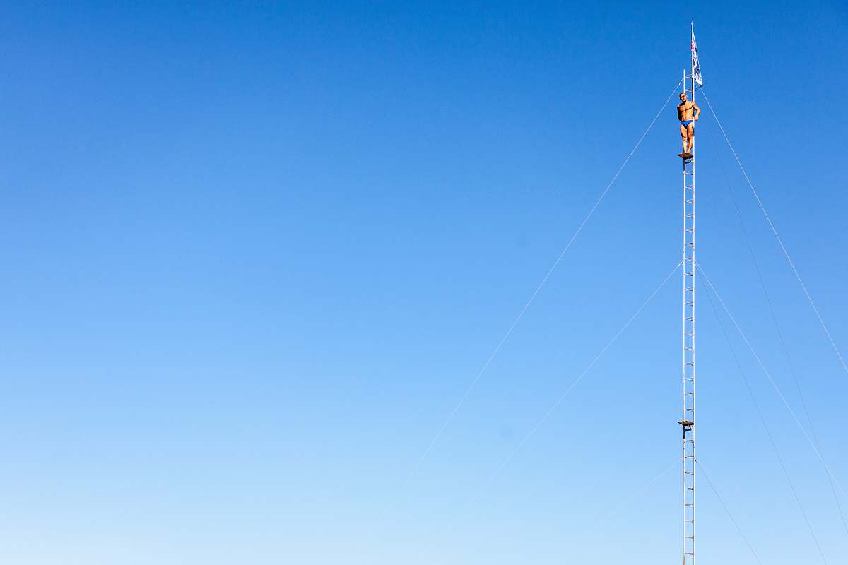 antenna man wearing blue brief standing ladder electrical device
