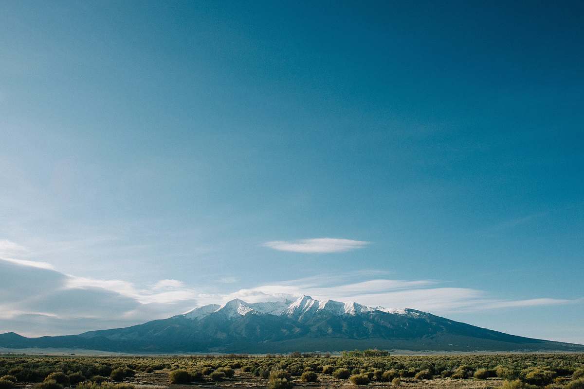 colorado mountain near grass field under cloudy sky field