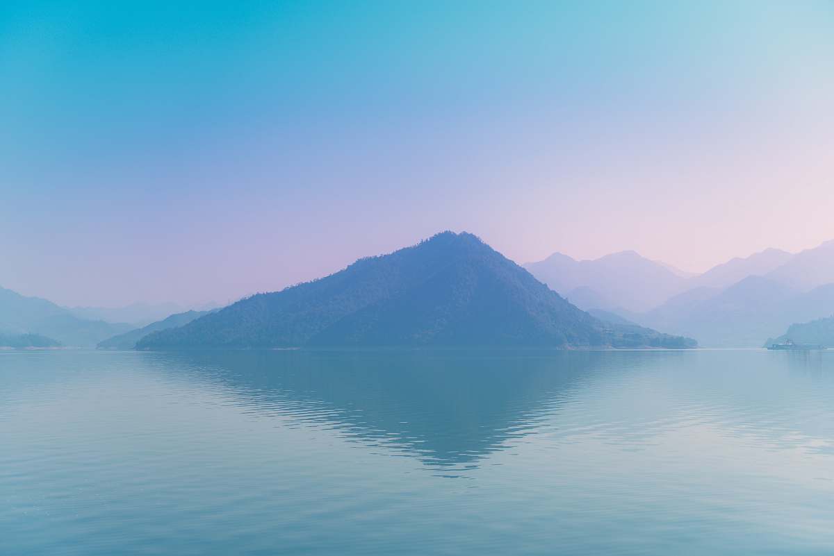 sunset mountain surround by body of water sunrise