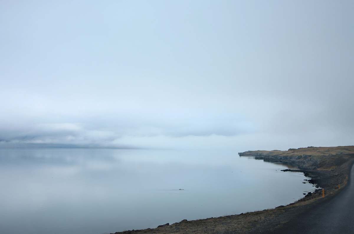 water mountains near body of water coast