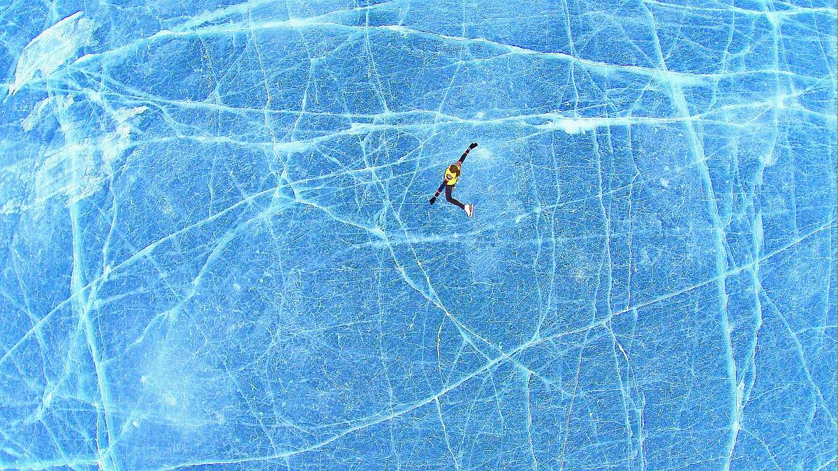 lake person falling on blue surface lake of the isles