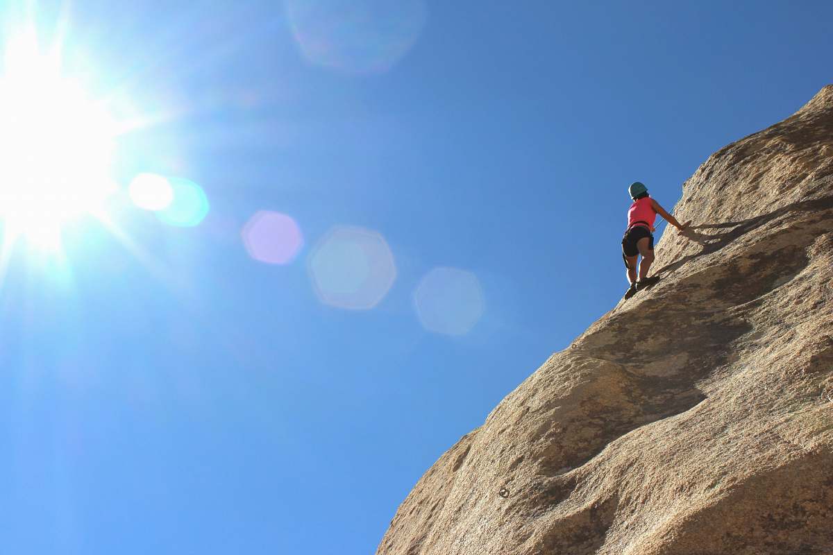 sport person rock climbing during day time climbing