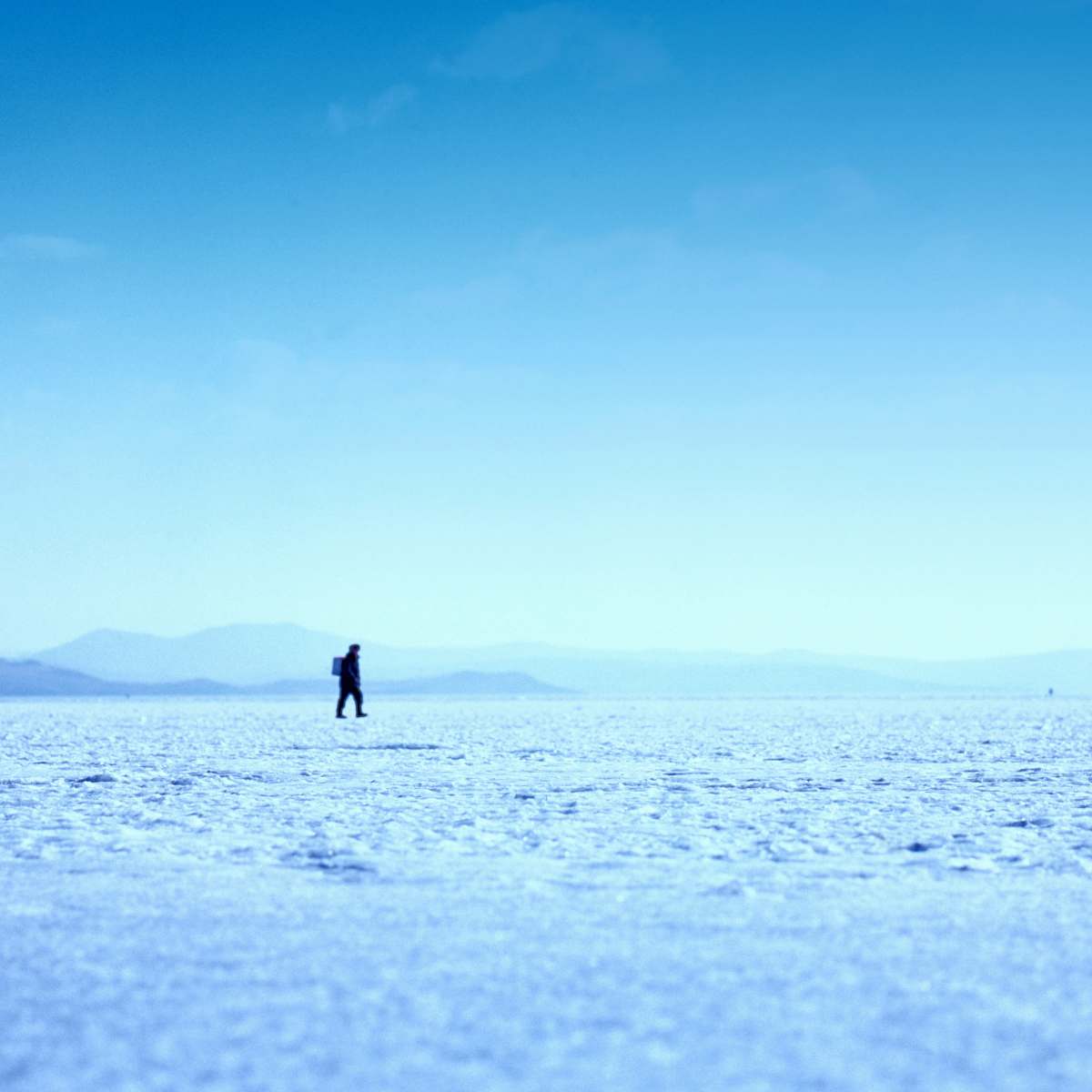 nature person walking on ice field photo sky