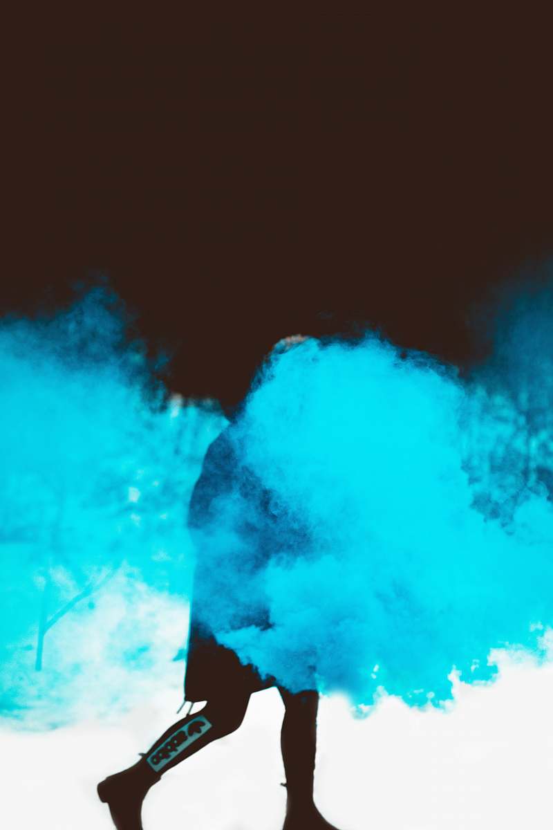 person person walks with blue smok smoke