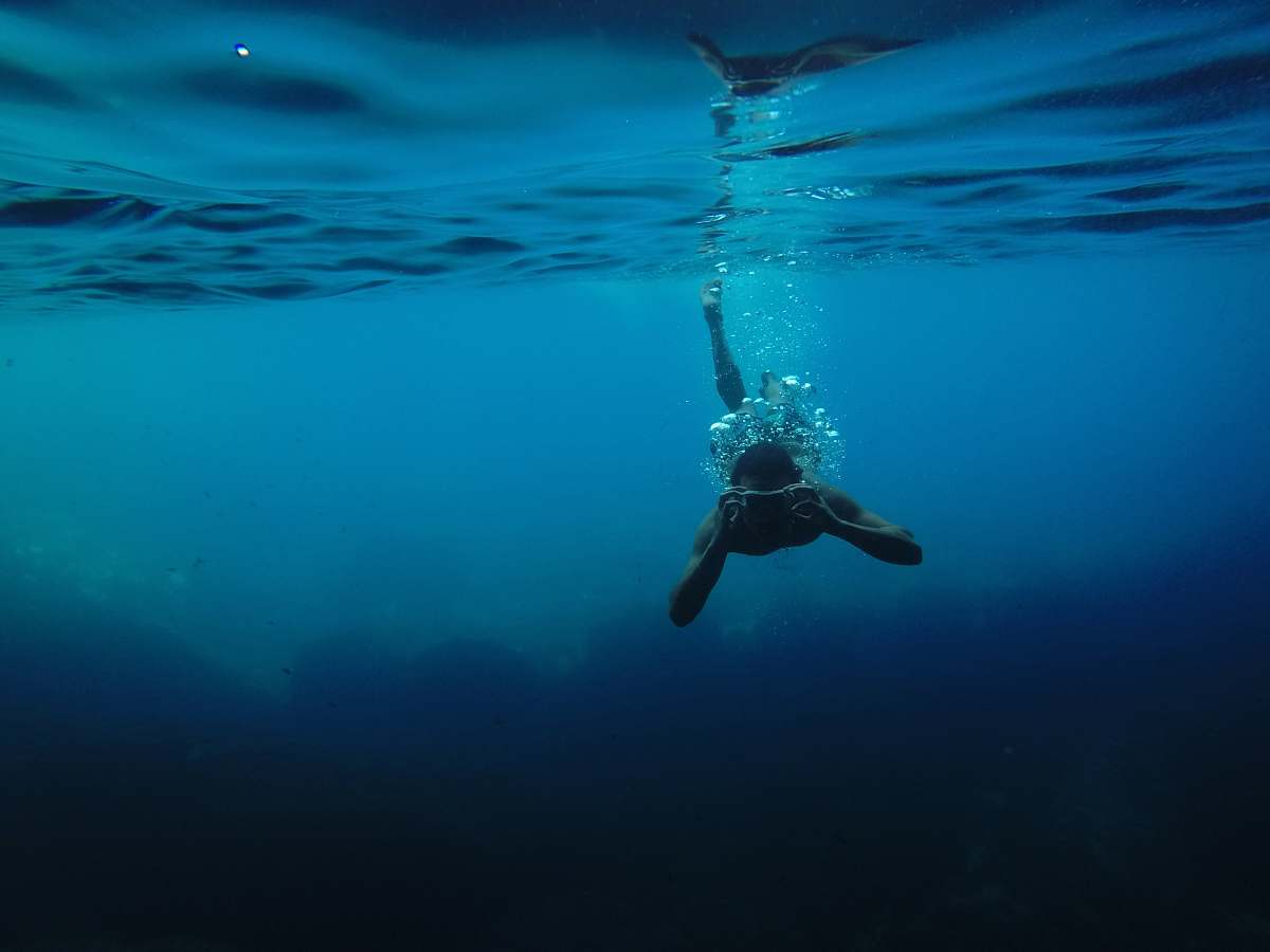 Underwater Person Wearing Goggles While Swimming Under Body Of Water ...