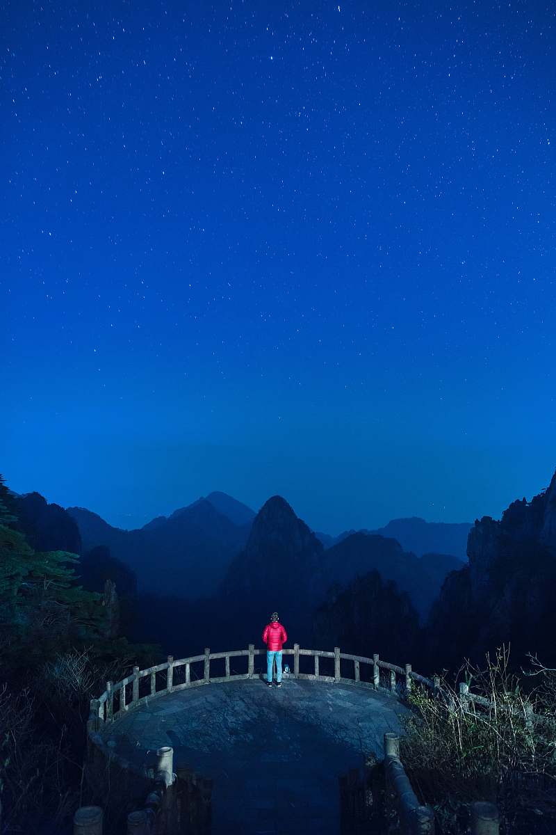 huangshan photo of man standing on brown concrete paving china