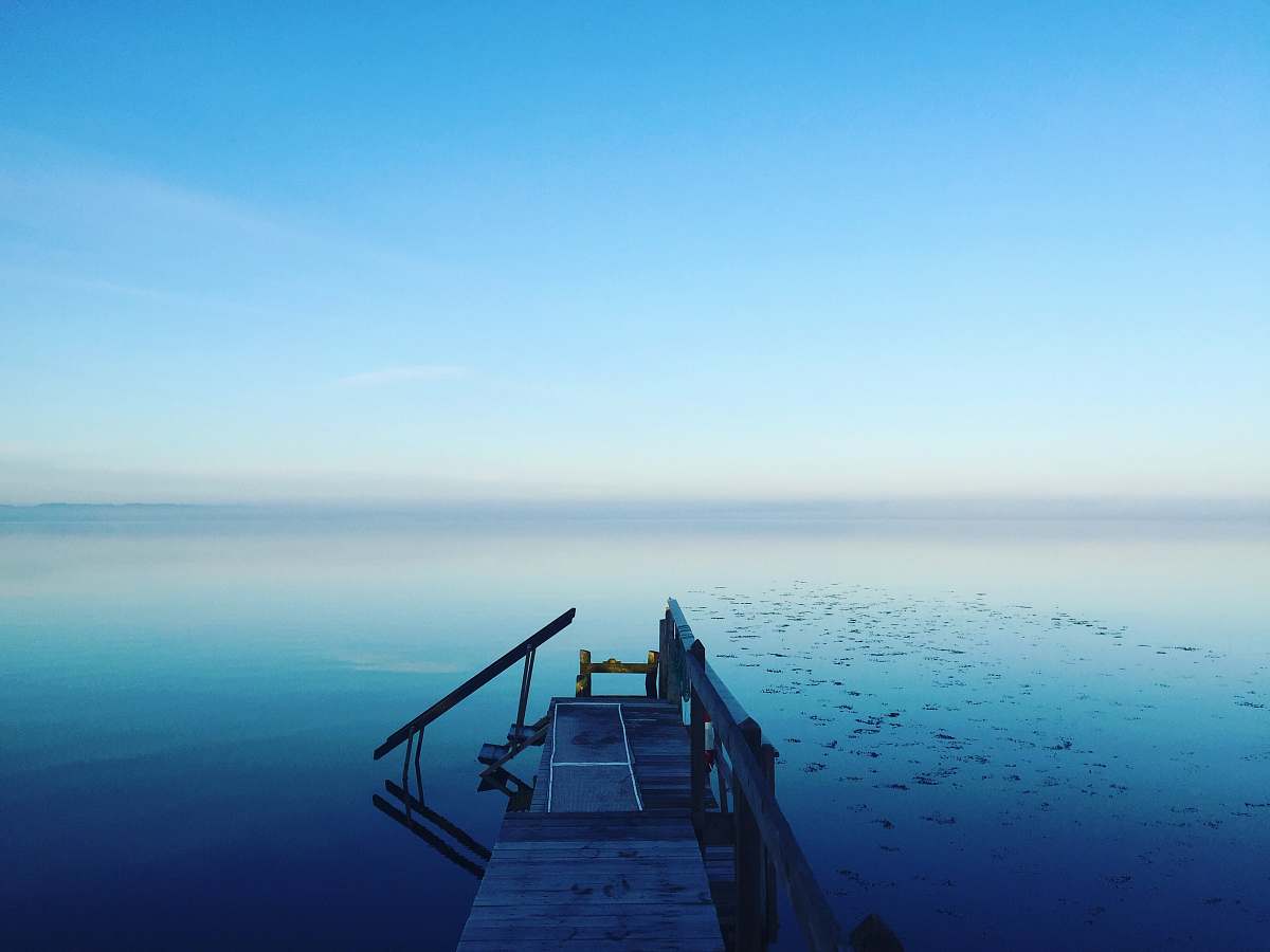 water photography of calm body of water horizon