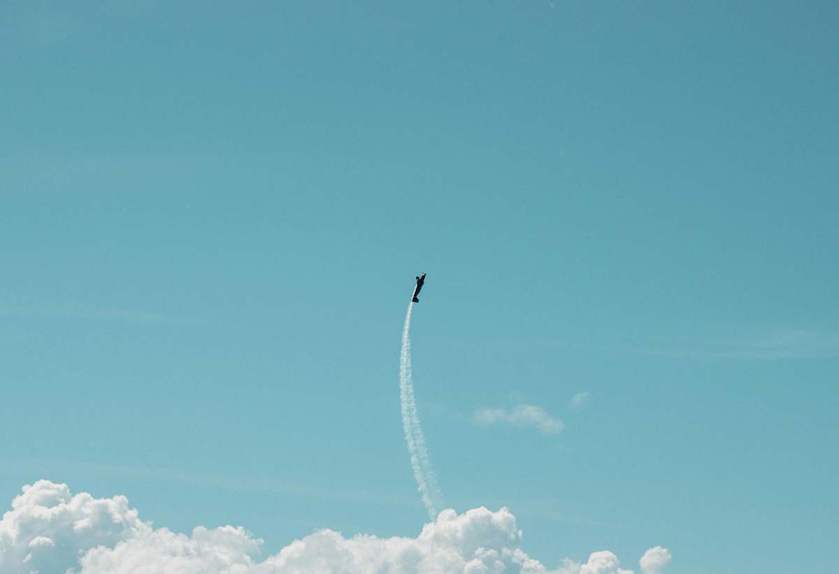 transportation plane flying with contrail during daytime vehicle