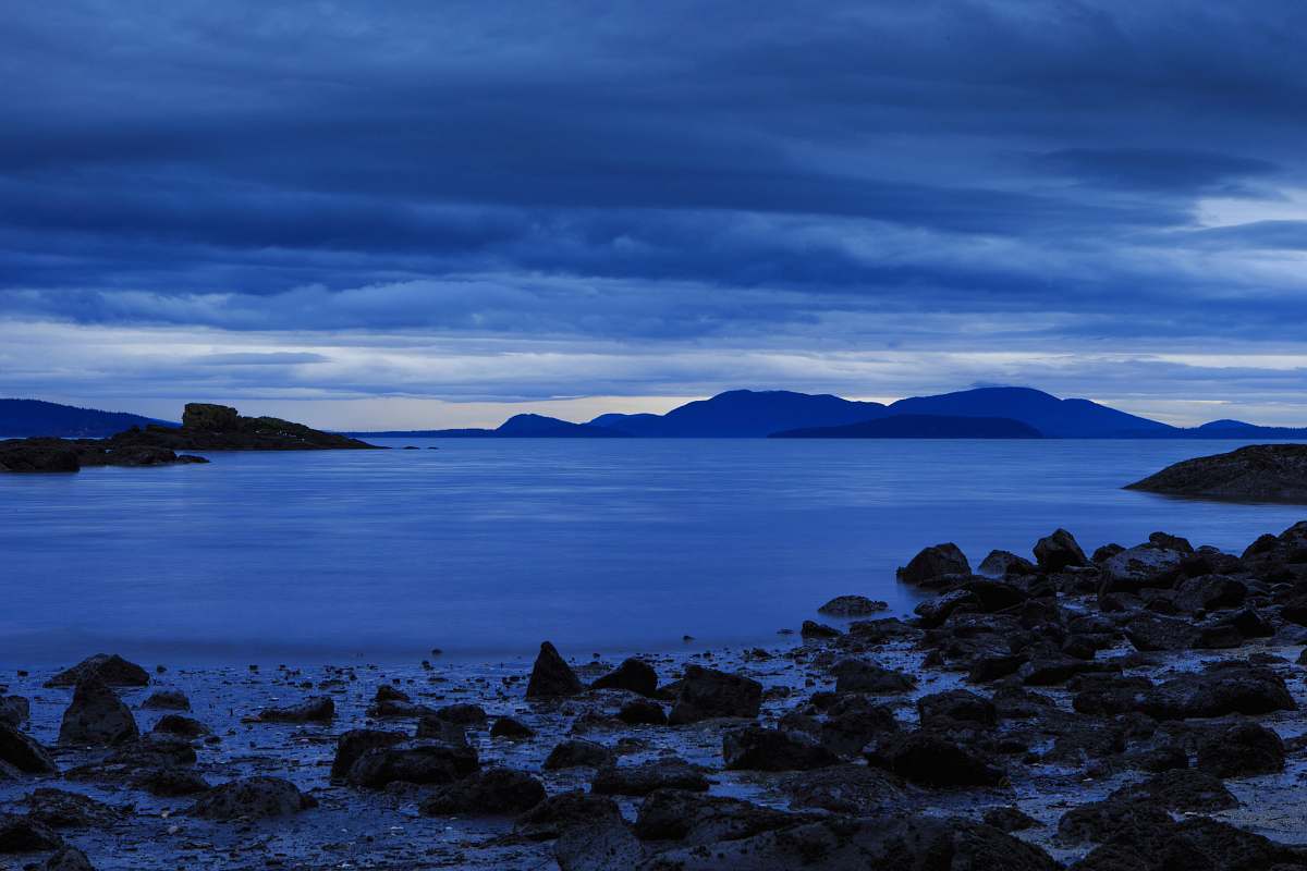 sea rocks on seashore under gray clouds coast