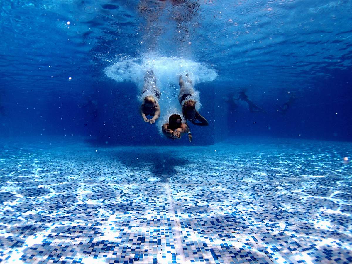 person three person diving on water water
