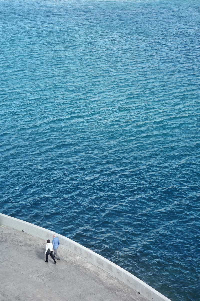 ocean two persons walking near body of water malta