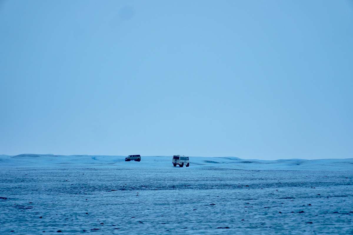 adventure white and black bus on snowy field under blue sky during daytime leisure activities
