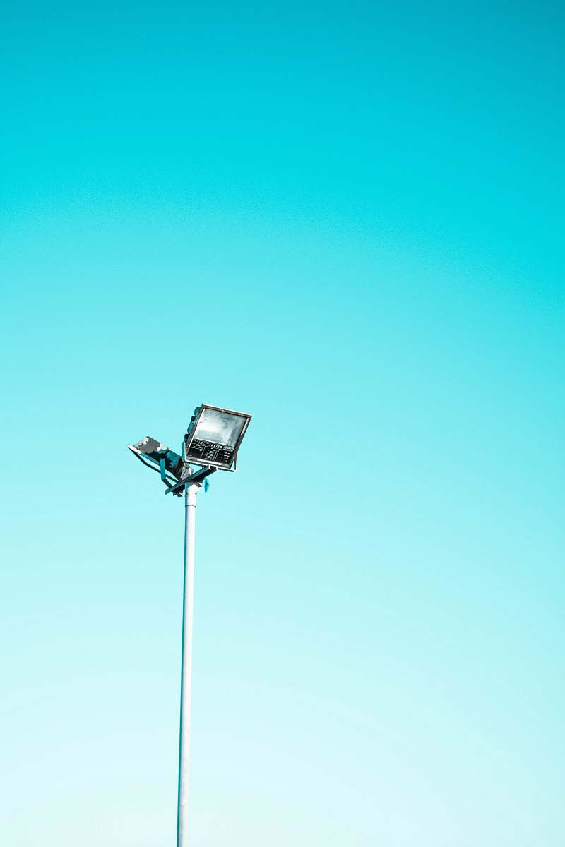 minimal white and black light post under blue sky blue sky