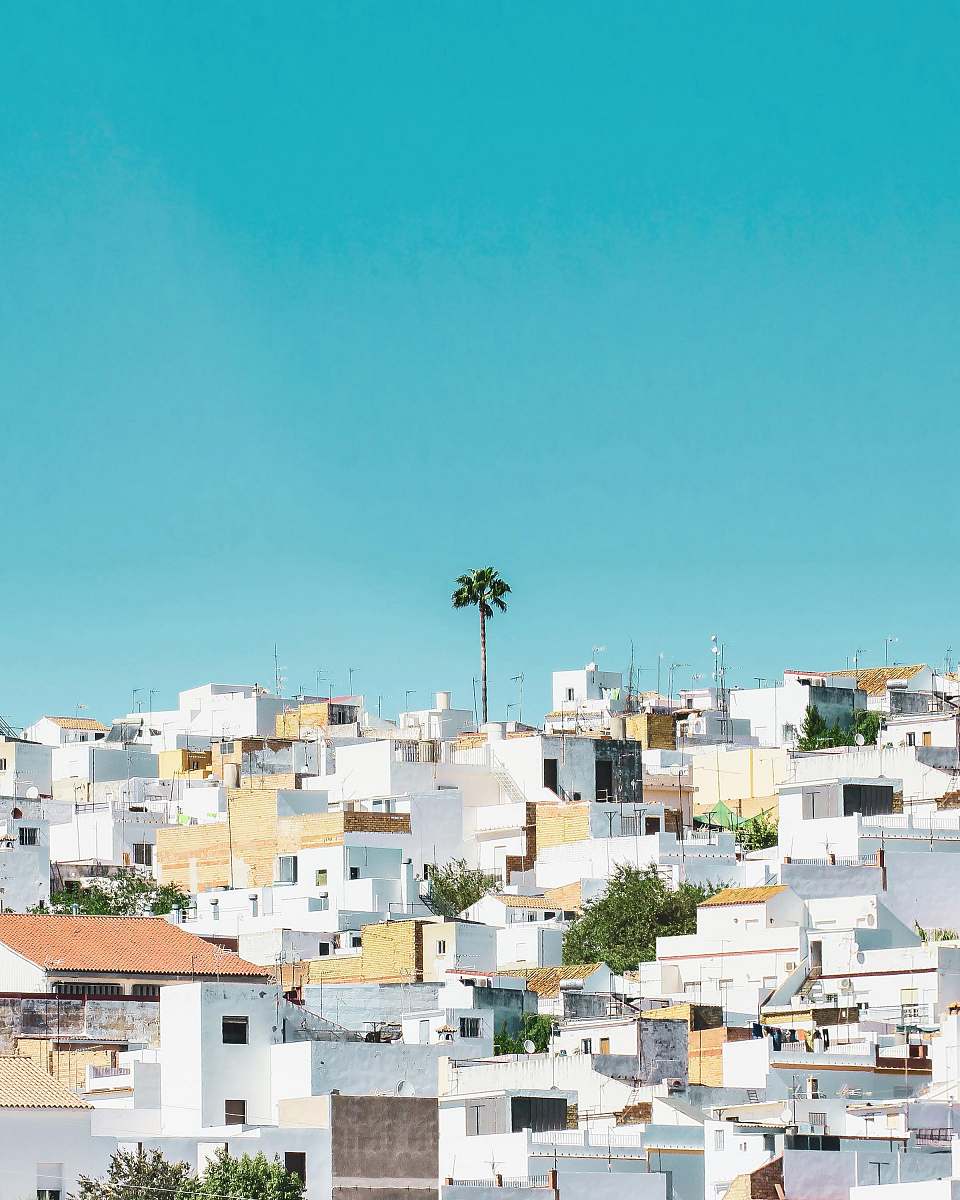 building white and brown concrete houses under blue sky during daytime spain