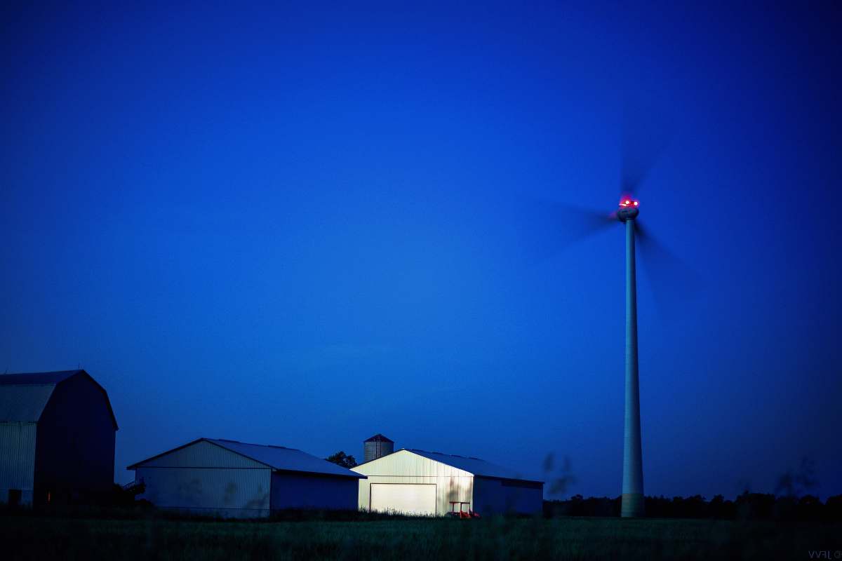 engine white barn beside windmill machine