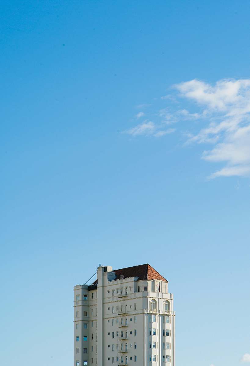 building white concrete building under blue sky apartment building
