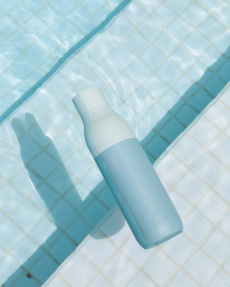 cosmetics white plastic bottle on pool bottle