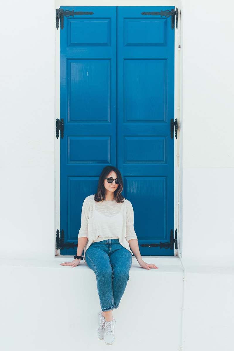 person woman in white shirt sitting on concrete surface people