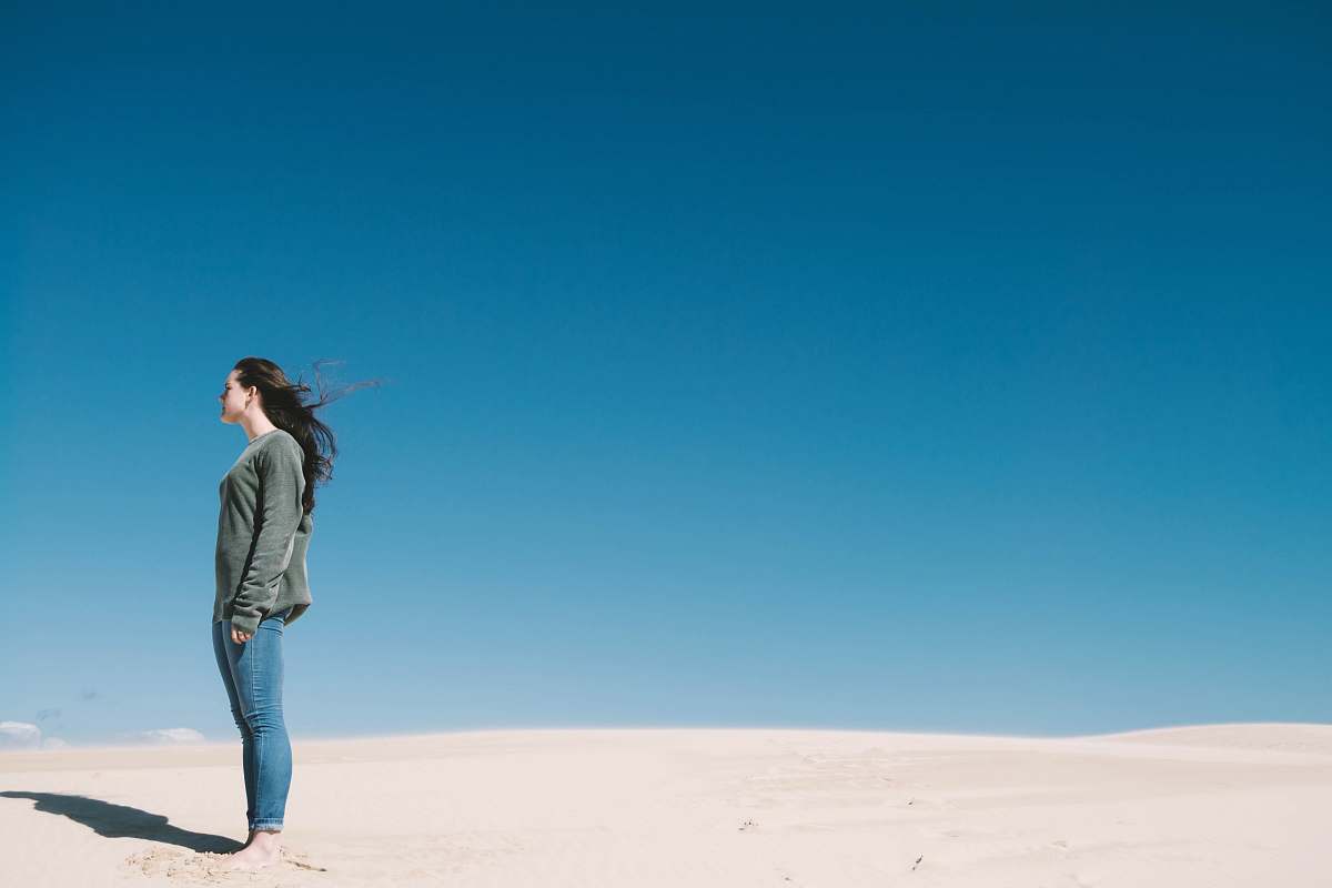 human woman standing on gray sand people
