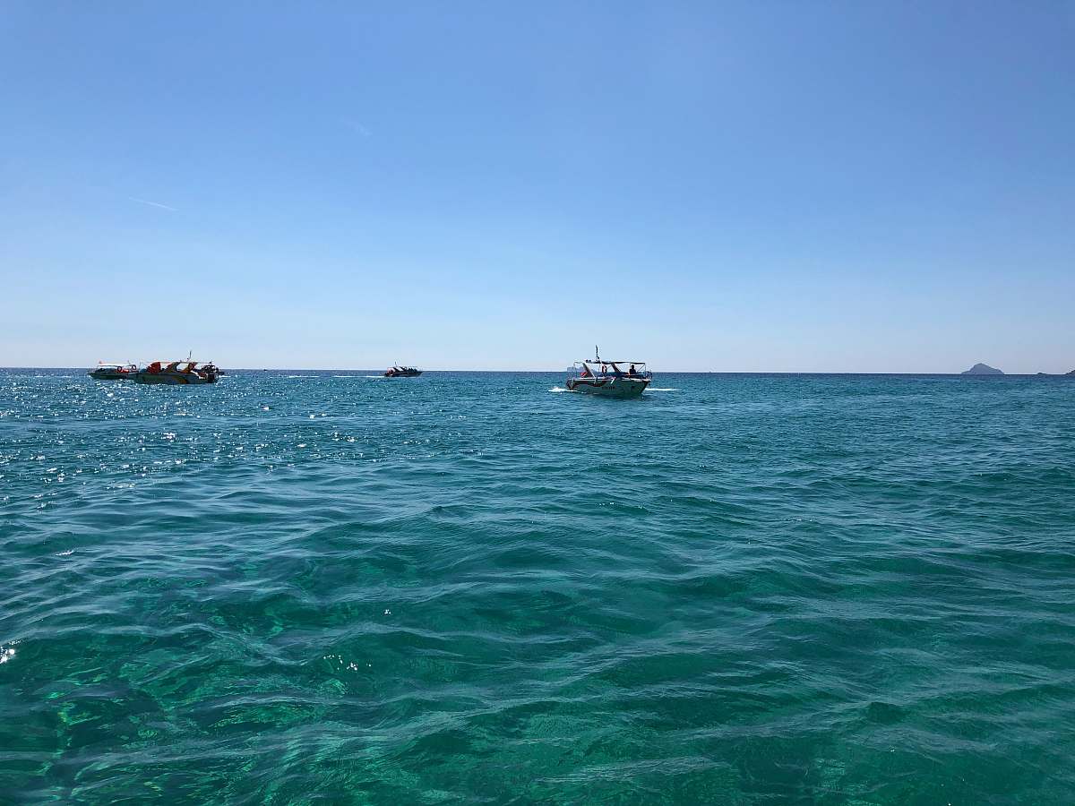 transportation powerboat on body of water under blue sky vehicle