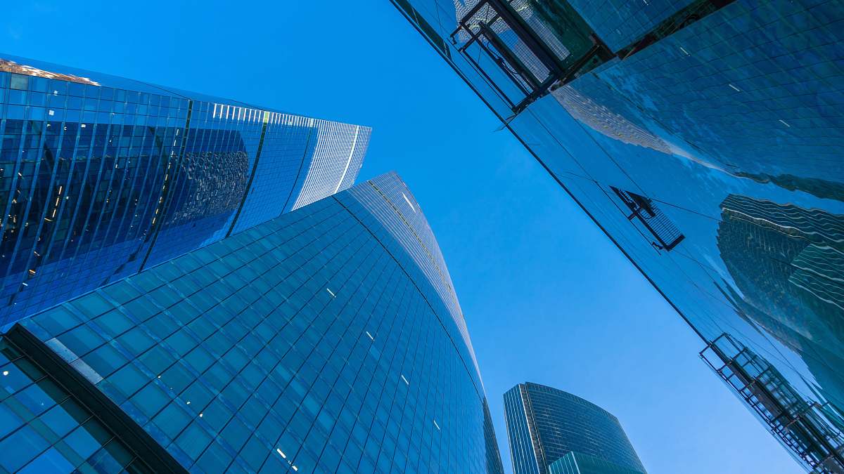 city low-angle photography of curtain wall under blue sky office building
