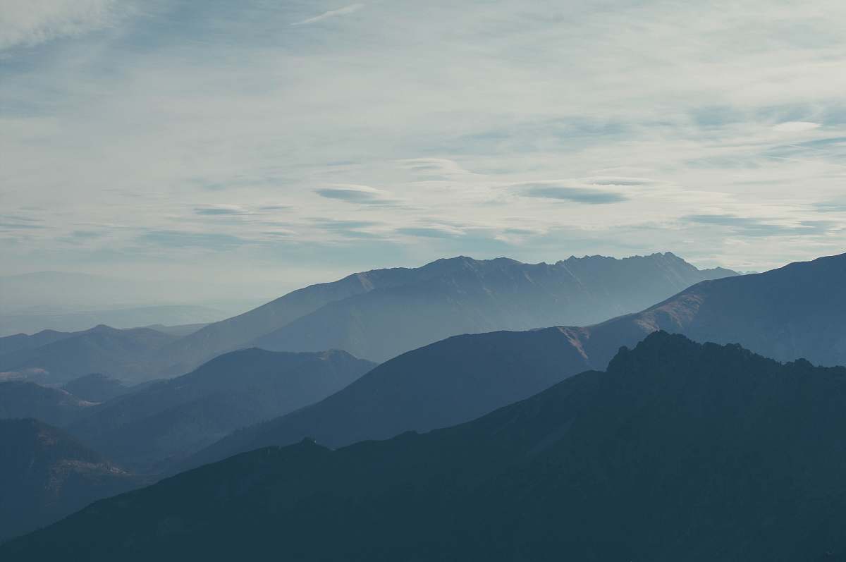 grey silhouette of mountains covered with fog mountain range