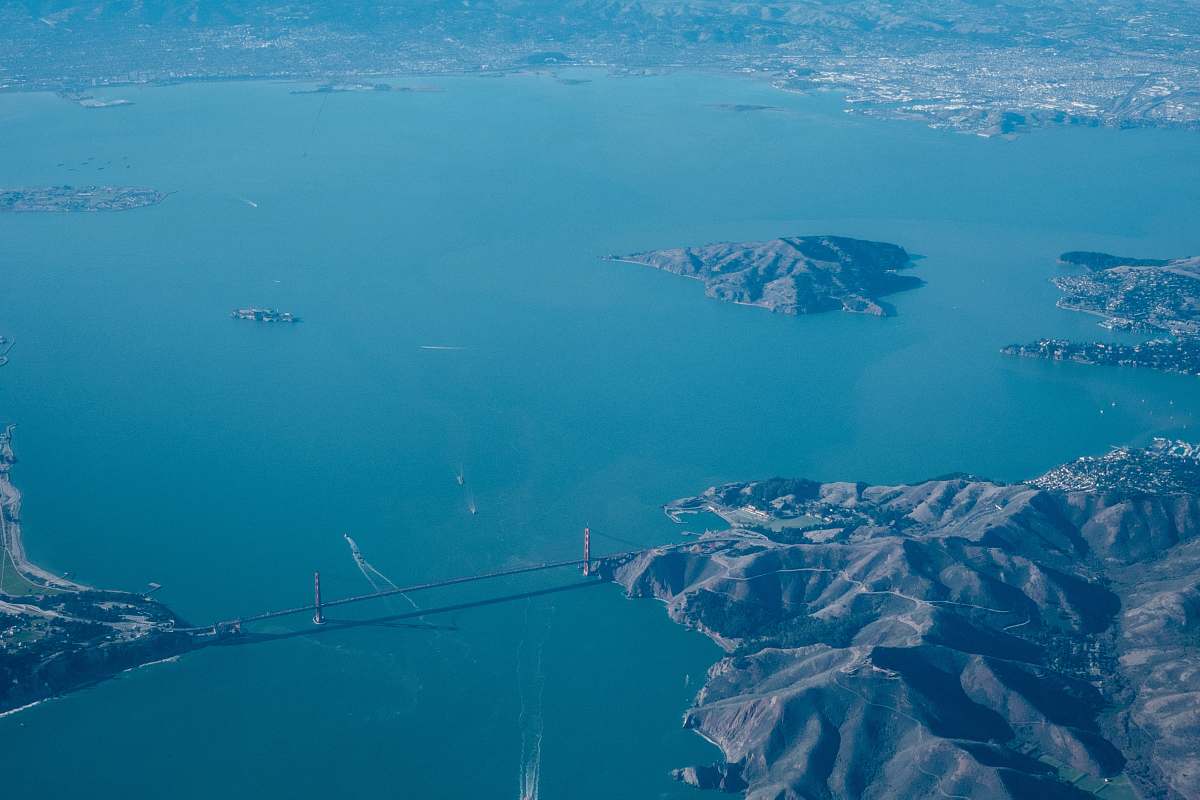 outdoors aerial view of mountains and islet during daytime landscape