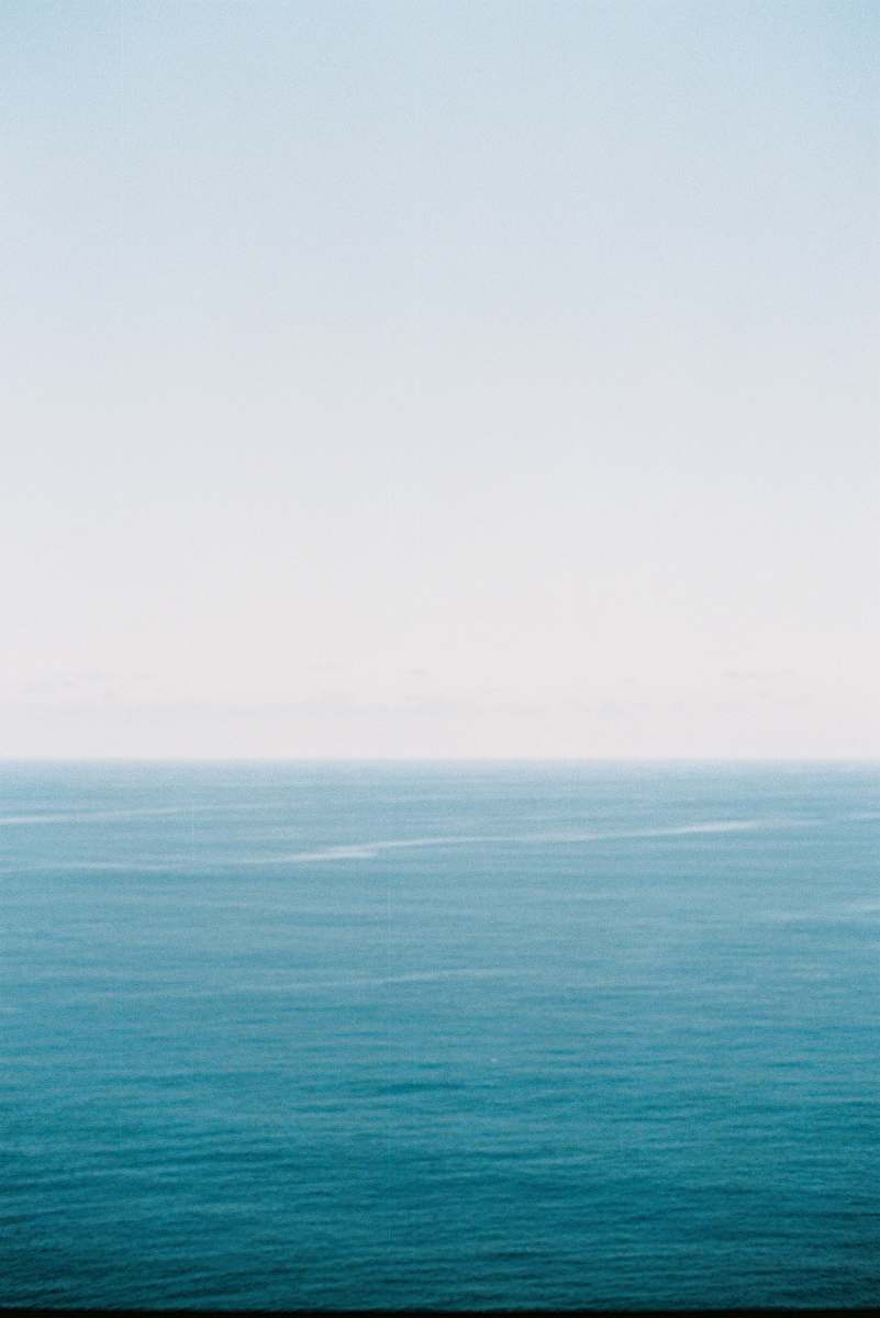 Experience the breathtaking beauty of a vibrant blue ocean viewed from a tranquil hilltop. This captivating scene captures the essence of natures splendor, perfect for travel brochures, lifestyle blogs, or outdoor adventure promotions. Ideal for evoking feelings of peace, freedom, and exploration, this image is a must-have for anyone seeking to convey the allure of coastal landscapes.