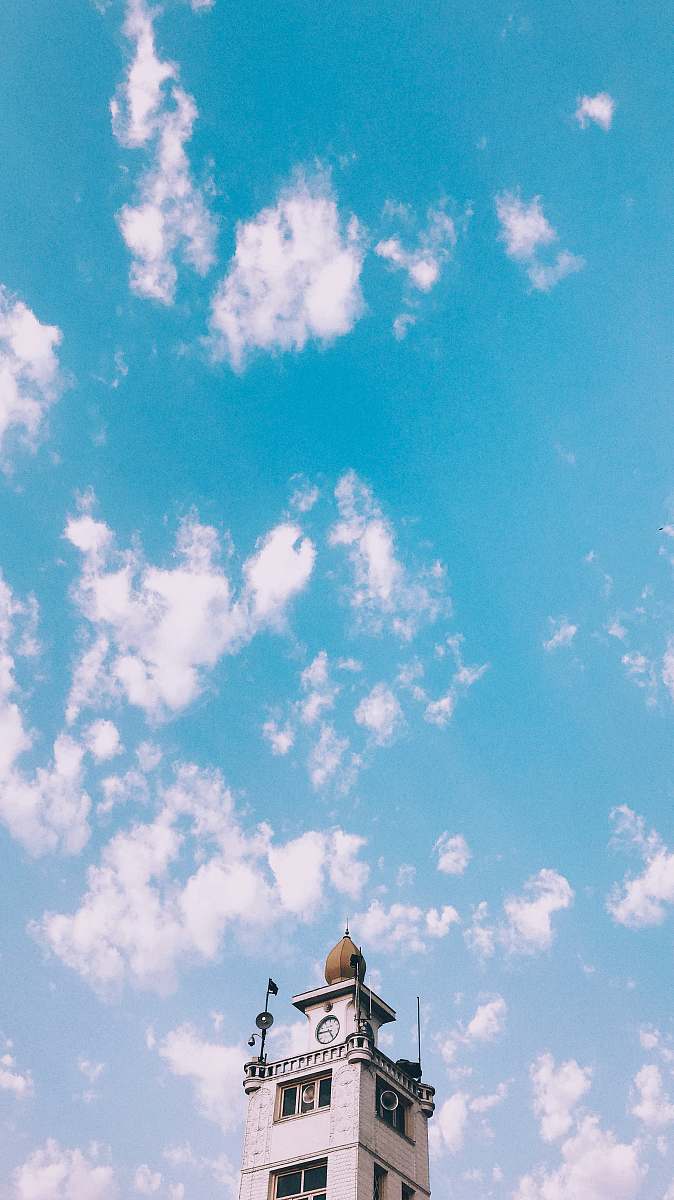 outdoors gray concrete tower during daytime azure sky