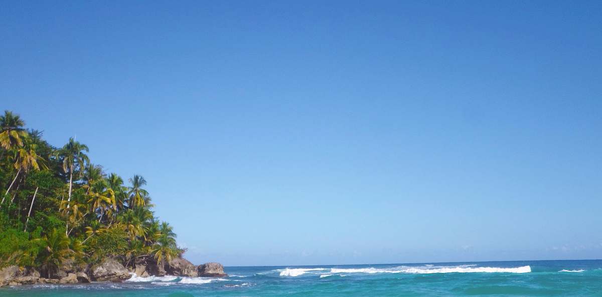 Experience the serene beauty of nature with this stunning outdoor photograph capturing powerful ocean waves surging against towering mountains during a bright daytime. The golden sandy beach in the foreground invites viewers to imagine the gentle sounds of the surf and the fresh ocean breeze. This versatile image is perfect for travel blogs, environmental campaigns, or any project celebrating the splendor of coastal landscapes.