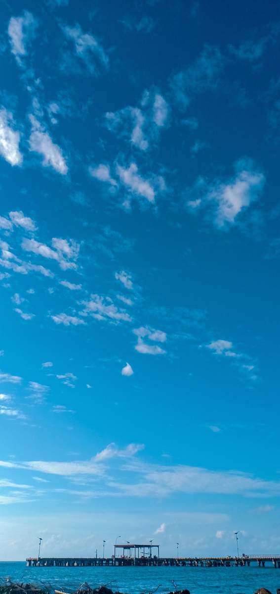 outdoors white and blue cloudy sky over the pier azure sky