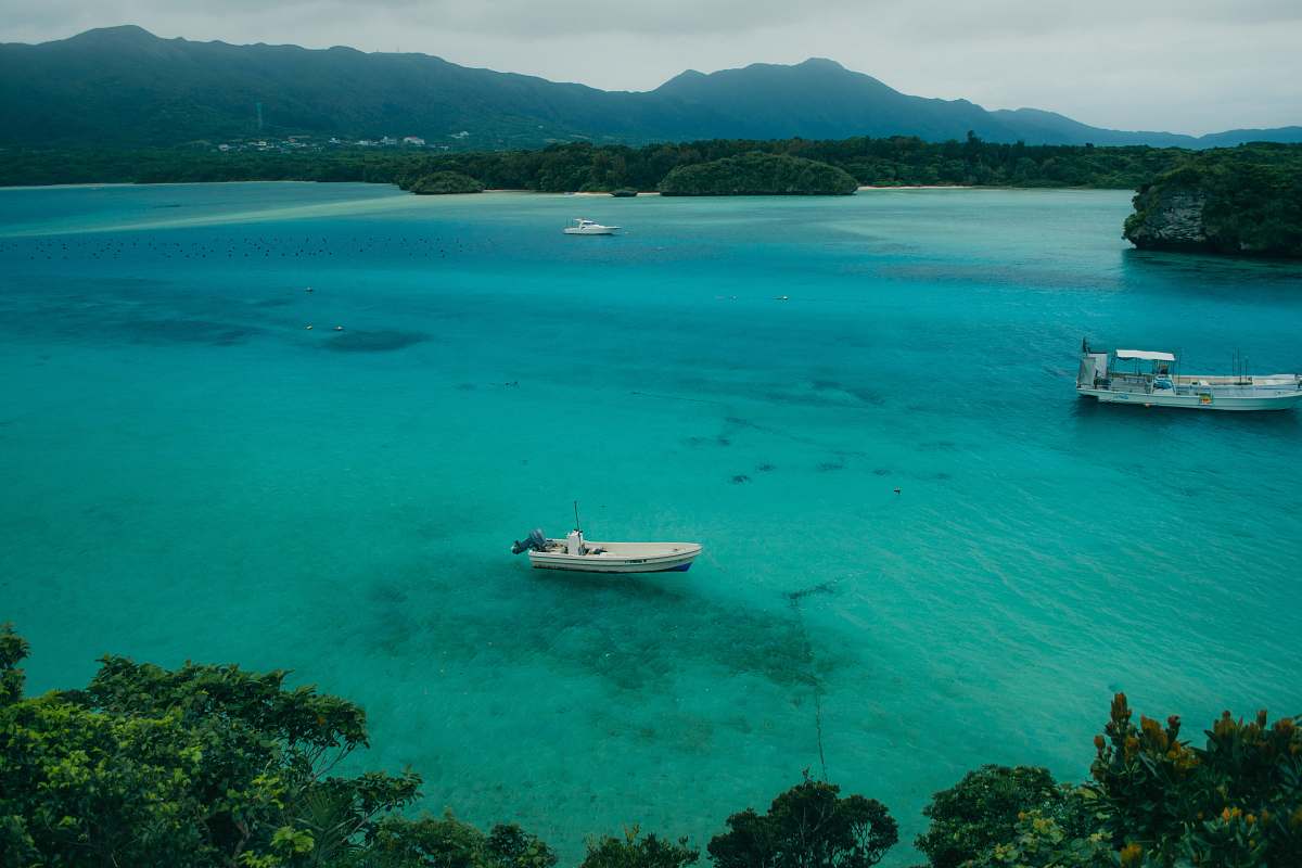outdoors white boat on body of water during daytime land