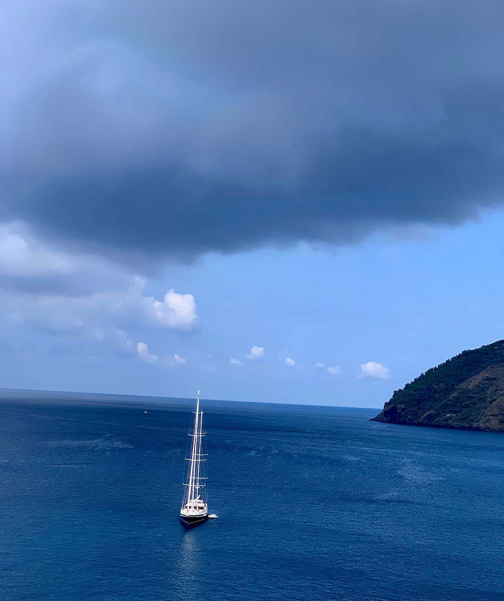 land white boat under grey clouds outdoors