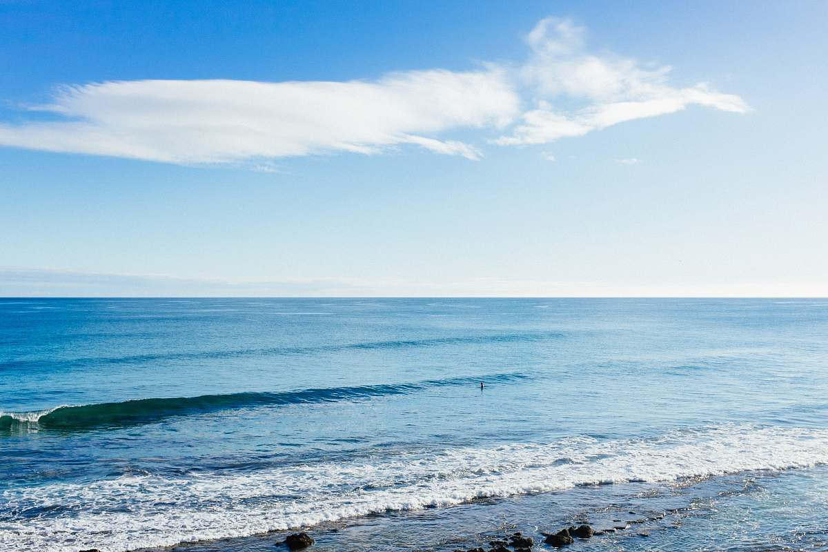 ocean white clouds in blue sky over tranquil beach sea