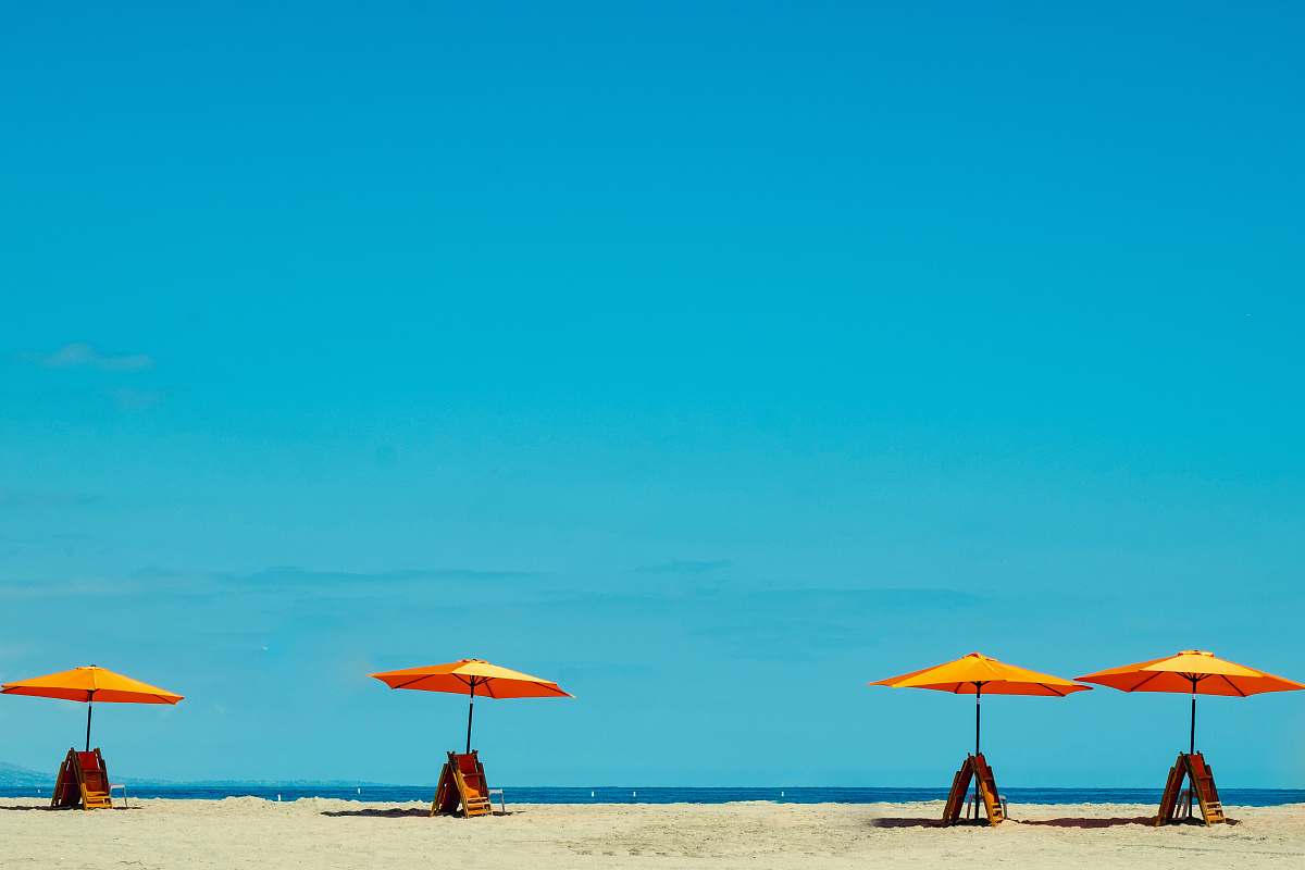 blue four yellow-and-orange parasols nature