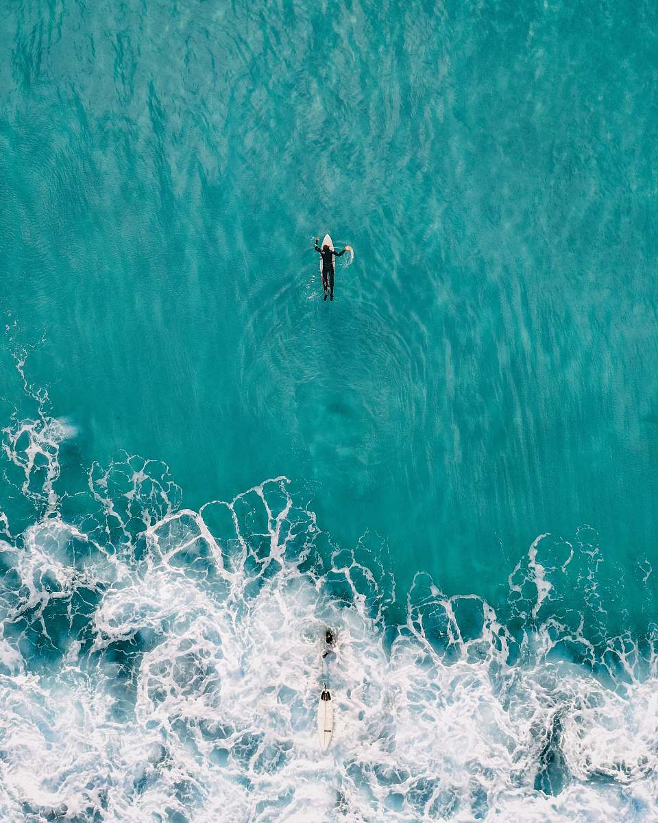 water person on white surfboard sea