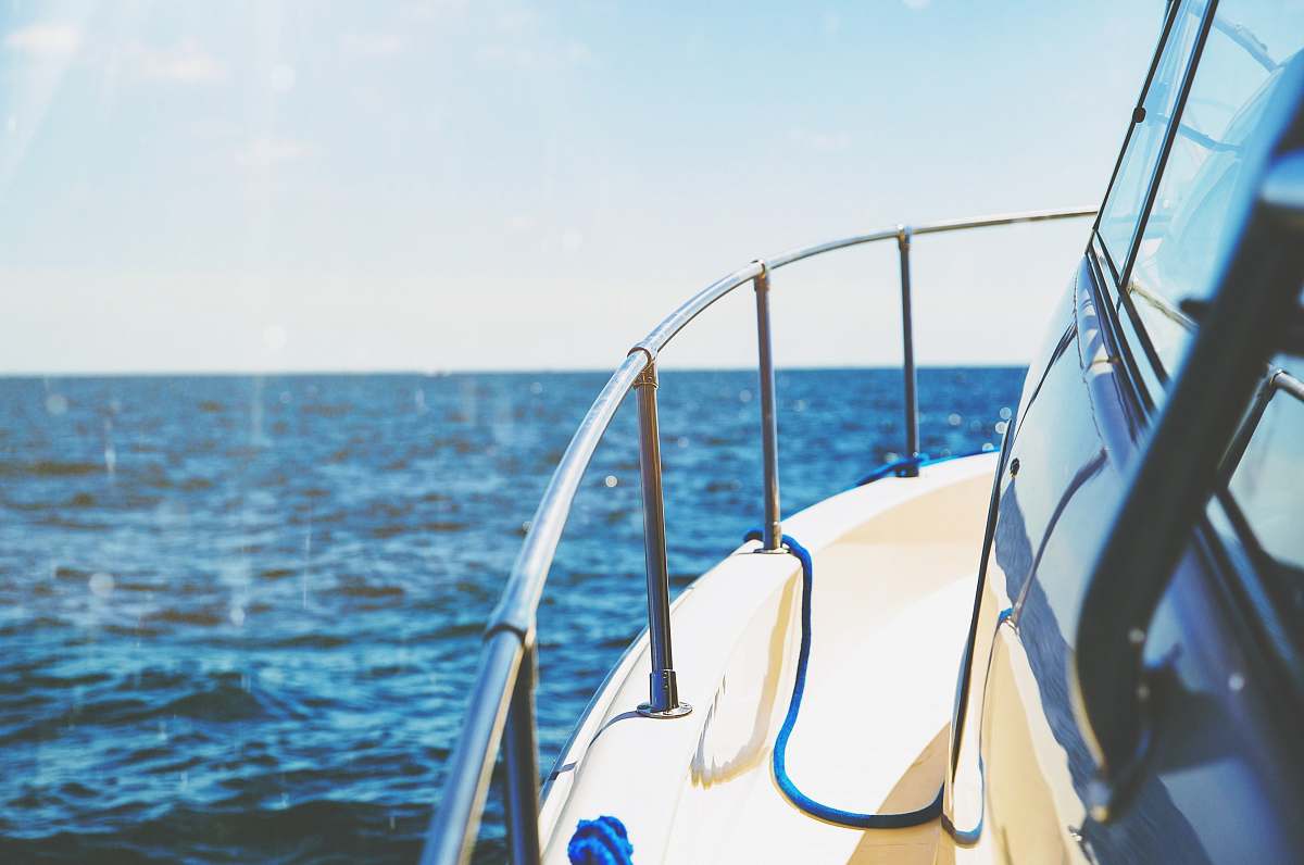 sea photo of white and gray ship in body of water boat