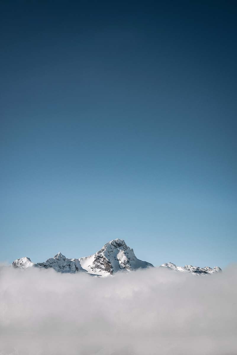 mountain selective focus photography of white mountain under blue calm sky alps