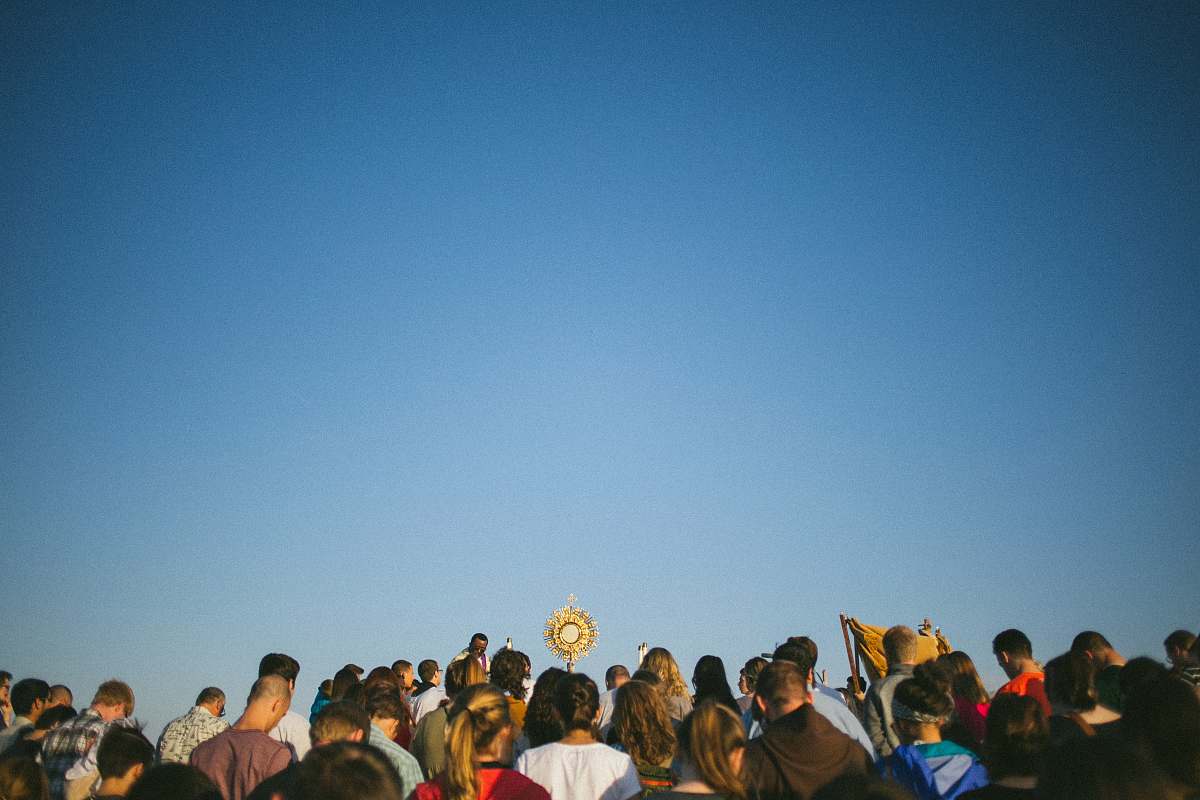 blue standing people during daytime crowd