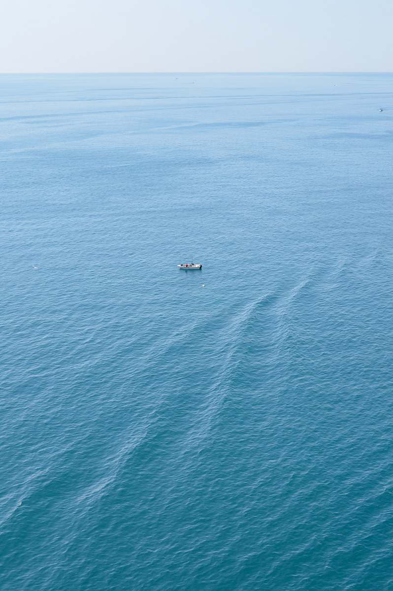 ocean boat on calm body of water water
