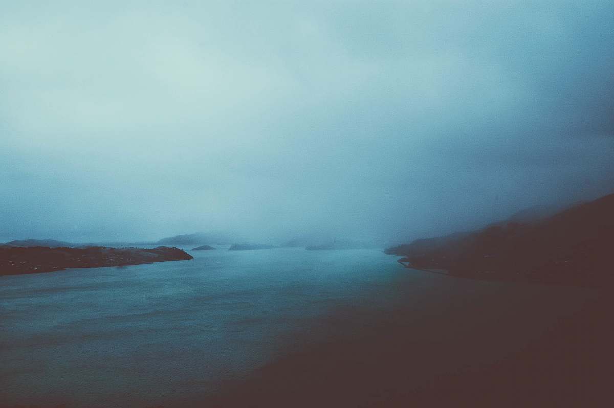 blue cloudy sky over calm body of water ocean