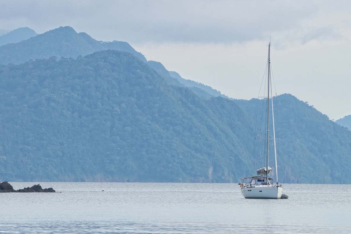 vehicle white sailboat at sea with folded sail vessel