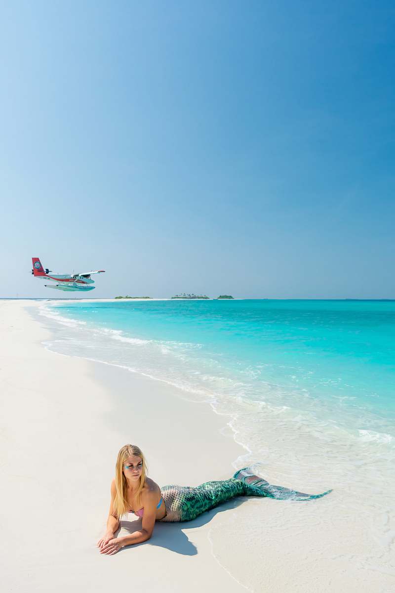 outdoors blonde-haired woman wearing green mermaid costume on seashore sea