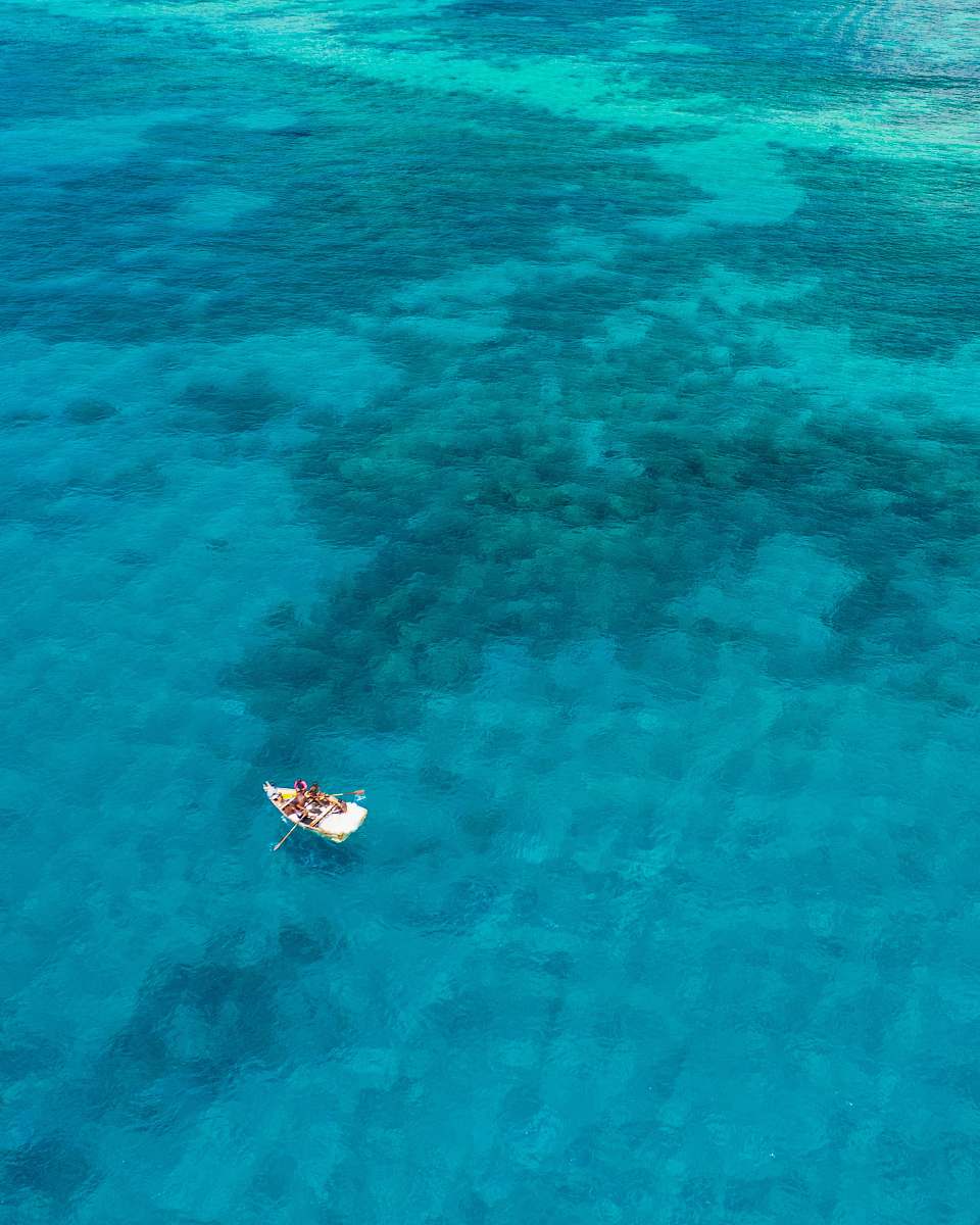 blue boat sailing on calm body of water nature
